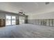 Bright living room features ceiling fan, recessed lighting, and large sliding glass doors at 14043 E Parsley Dr, Madeira Beach, FL 33708