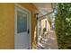 Side entrance to the home with a white door, exterior light and drain spout at 14043 E Parsley Dr, Madeira Beach, FL 33708
