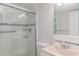 Bathroom features a glass door shower, modern fixtures, and a decorative mirror at 1552 Pleasant Rd # J4, Bradenton, FL 34207