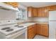 Functional kitchen with white appliances, ample cabinet space, and a window offering natural light at 1552 Pleasant Rd # J4, Bradenton, FL 34207