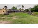 Expansive backyard with lush green grass leading to a screened-in pool enclosure at 16403 Bonneville Dr, Tampa, FL 33624