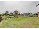 Large grassy backyard with a dock overlooking a pond at 16403 Bonneville Dr, Tampa, FL 33624