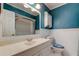 Bathroom featuring teal walls, a white tiled floor, and a large vanity mirror at 16403 Bonneville Dr, Tampa, FL 33624