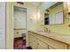 Bathroom with a light yellow vanity and marble countertops, and a toilet area at 16403 Bonneville Dr, Tampa, FL 33624