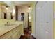 Bathroom with a light yellow vanity, and white closet doors at 16403 Bonneville Dr, Tampa, FL 33624