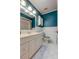 Bathroom with a white tiled floor, vanity, and accent wall at 16403 Bonneville Dr, Tampa, FL 33624