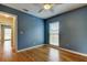 Bedroom features a ceiling fan, hardwood floors, and a window for natural light at 16403 Bonneville Dr, Tampa, FL 33624