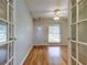 Bright bedroom with hardwood floors, a ceiling fan, and a large window for natural light at 16403 Bonneville Dr, Tampa, FL 33624
