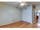 Bright bedroom with hardwood floors, a ceiling fan, and a double closet for storage at 16403 Bonneville Dr, Tampa, FL 33624