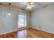 Well-lit bedroom with hardwood floors, a ceiling fan, and a view of the neighborhood at 16403 Bonneville Dr, Tampa, FL 33624