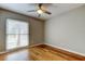 Comfortable bedroom with a ceiling fan and large window, offering plenty of natural light at 16403 Bonneville Dr, Tampa, FL 33624