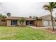 Charming single-story home with a well-manicured lawn and an attached two-car garage at 16403 Bonneville Dr, Tampa, FL 33624