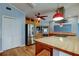Contemporary kitchen with stainless appliances, light wood cabinetry, and hardwood flooring at 16403 Bonneville Dr, Tampa, FL 33624