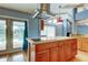 Kitchen island with stainless appliances, hardwood flooring, and french doors to pool at 16403 Bonneville Dr, Tampa, FL 33624