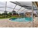 Screened-in pool with brick paver patio, and well-maintained landscaping at 16403 Bonneville Dr, Tampa, FL 33624