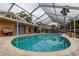 Screened-in pool with brick paver patio, and backyard at 16403 Bonneville Dr, Tampa, FL 33624