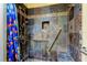 Tiled shower with pebble flooring, a built-in shelf, and a handrail at 16403 Bonneville Dr, Tampa, FL 33624