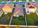Aerial view of backyard featuring a screened in porch, lush lawn and fenced in yard at 16805 Delia St, Wimauma, FL 33598