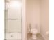 Clean bathroom with a glass-enclosed shower and modern toilet at 16805 Delia St, Wimauma, FL 33598