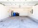 Spacious two-car garage with overhead storage racks and ample room for vehicles at 16805 Delia St, Wimauma, FL 33598