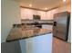 Modern kitchen features stainless steel appliances, granite countertops, and white cabinetry at 16805 Delia St, Wimauma, FL 33598