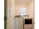 A functional laundry room with modern washer and dryer and storage space at 16805 Delia St, Wimauma, FL 33598