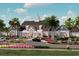Community center with inviting entrance, lush landscaping, and ample parking at 18051 Foxtail Loop, Venice, FL 34293