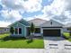 Charming single-story home with a well-manicured lawn, brick driveway, and attached two-car garage at 18051 Foxtail Loop, Venice, FL 34293