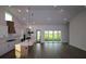 Gourmet kitchen with white cabinets, an island with seating, and an open layout with sliding glass doors at 18051 Foxtail Loop, Venice, FL 34293