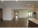 Spacious open floor plan with wood flooring and recessed lighting; great room flows from kitchen at 18051 Foxtail Loop, Venice, FL 34293