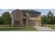 Beautiful two-story home featuring a stone facade, attached two car garage, and manicured front yard at 18448 Serene Lake Loop, Lutz, FL 33548