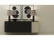 Stylish living room featuring a modern console table adorned with contemporary art and elegant lamps at 18448 Serene Lake Loop, Lutz, FL 33548