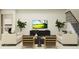 Inviting living room with comfortable seating, modern decor, and a TV creating a cozy gathering space at 18448 Serene Lake Loop, Lutz, FL 33548