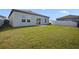 View of the backyard featuring a well-maintained lawn and sliding glass door at 2232 Harris Hawk, Ruskin, FL 33570