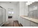 Bright bathroom with wood-look floors and granite counters, plus access to the bedroom at 2232 Harris Hawk, Ruskin, FL 33570