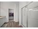 Bathroom with wood-look floors, stand-up shower, and access to the closet at 2232 Harris Hawk, Ruskin, FL 33570