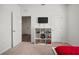 Bedroom with neutral carpet and white cube shelving unit with TV at 2232 Harris Hawk, Ruskin, FL 33570