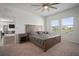 Comfortable carpeted bedroom with ceiling fan, natural light, and a view of the backyard at 2232 Harris Hawk, Ruskin, FL 33570