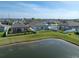 A picturesque view of a backyard with a pond in a residential neighborhood at 2232 Harris Hawk, Ruskin, FL 33570