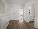 Foyer with wood floors and white wainscoting leads to the bedroom and bathroom at 2232 Harris Hawk, Ruskin, FL 33570