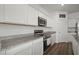 Modern kitchen featuring granite countertops, stainless steel appliances, and ample cabinet space at 2232 Harris Hawk, Ruskin, FL 33570