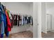Spacious walk-in closet with wire shelving racks, carpet flooring, and access to bathroom at 2232 Harris Hawk, Ruskin, FL 33570