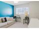 Bedroom featuring turquoise accent wall, and couch with throw pillows at 2348 Shelley St # 2, Clearwater, FL 33765