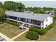 Two-story building featuring a well-maintained green lawn and stairs leading to the upper level units at 2348 Shelley St # 2, Clearwater, FL 33765