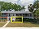 Two-story condo showcasing balconies, brick accents, and a well-maintained landscape at 2348 Shelley St # 2, Clearwater, FL 33765