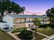 Exterior shot of a two-story condo with balconies, a brick facade, and well-kept landscaping at 2348 Shelley St # 2, Clearwater, FL 33765