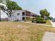 Two-story building with tropical trees and landscaping, a well-maintained yard and covered walkways at 2348 Shelley St # 2, Clearwater, FL 33765