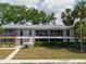 Two-story building with white brick, covered balconies and maintained landscaping in a cozy complex at 2348 Shelley St # 2, Clearwater, FL 33765