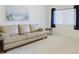 Neutral living room featuring a comfortable sofa, light-filled window, and stylish decor at 2348 Shelley St # 2, Clearwater, FL 33765