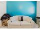 Bright living room with blue accent wall and modern striped couch with decorative pillows at 2348 Shelley St # 2, Clearwater, FL 33765